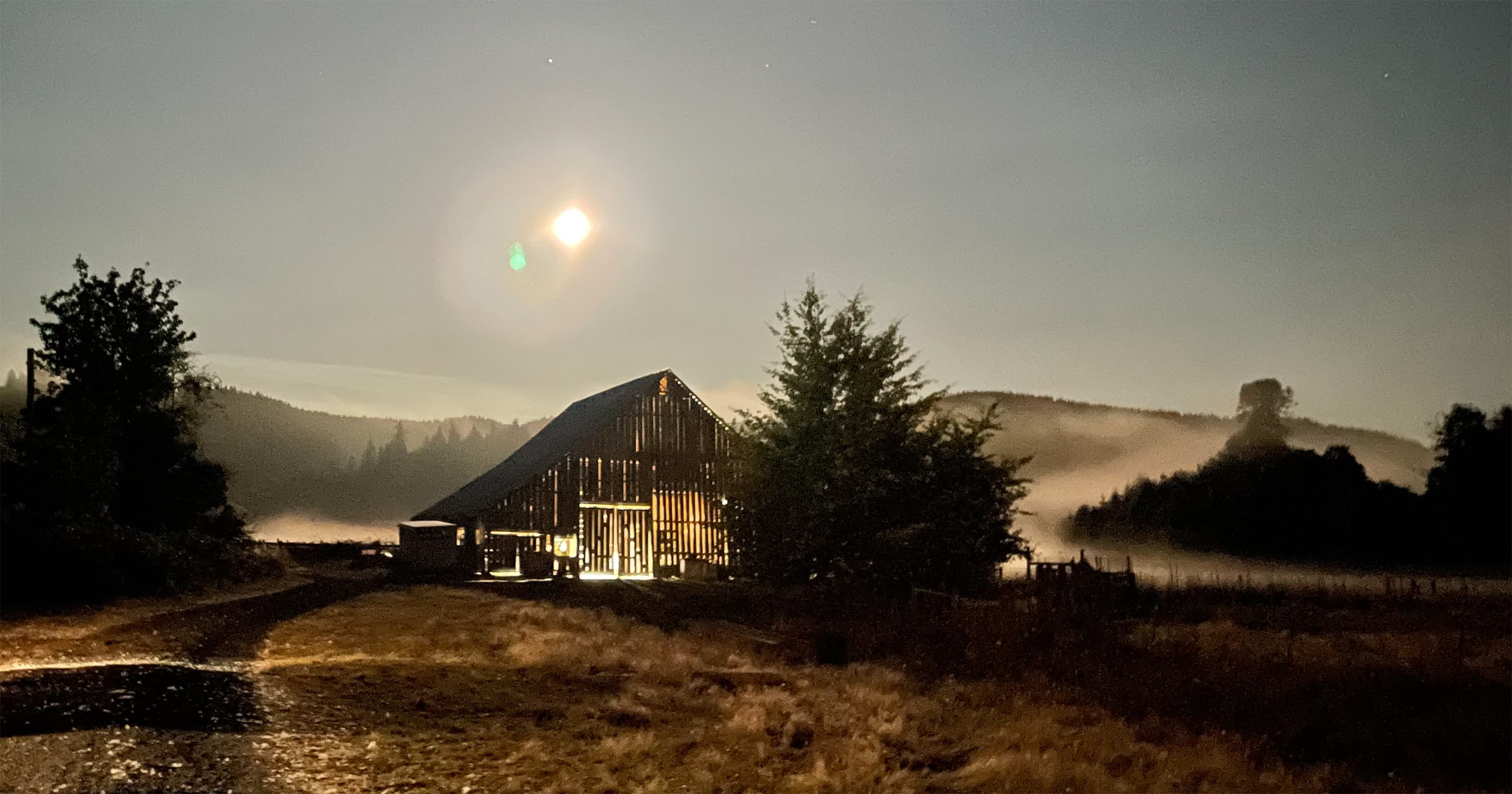 Moonlit barn and pasture at Sea Breeze Farm.